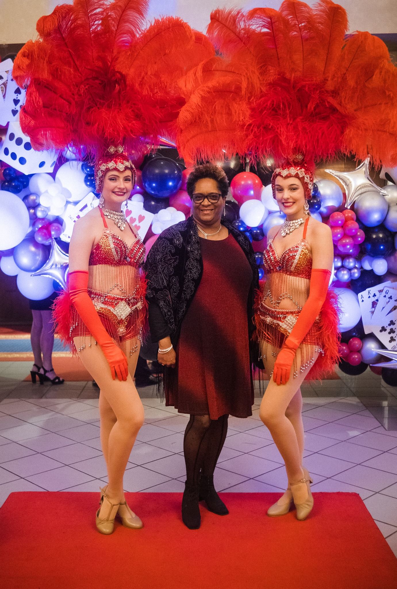 Casino Knight showgirls posing with a guest at a casino party