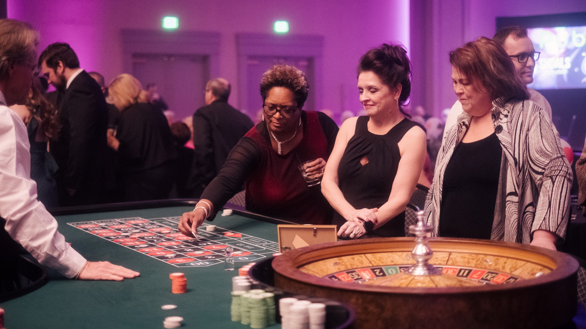 Guests playing roulette with a professional casino dealer